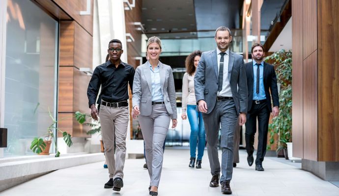 group of people walking in office attire